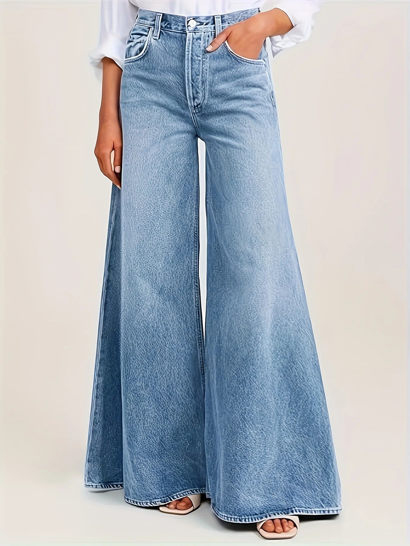 Women's light blue wide leg jeans with high waist and loose fit silhouette